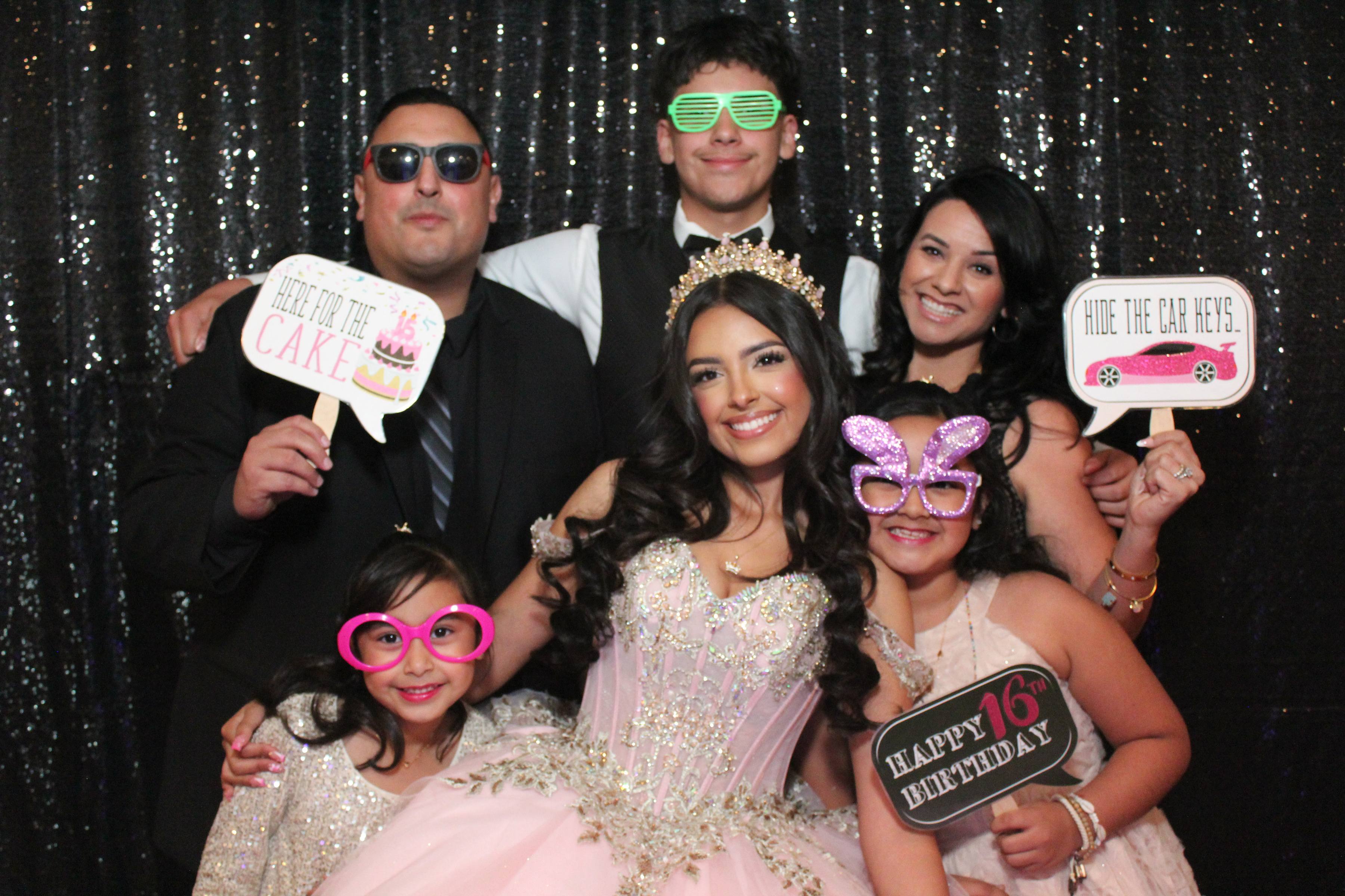 Quinceañera with pink gown and props on sequin backdrop, California event